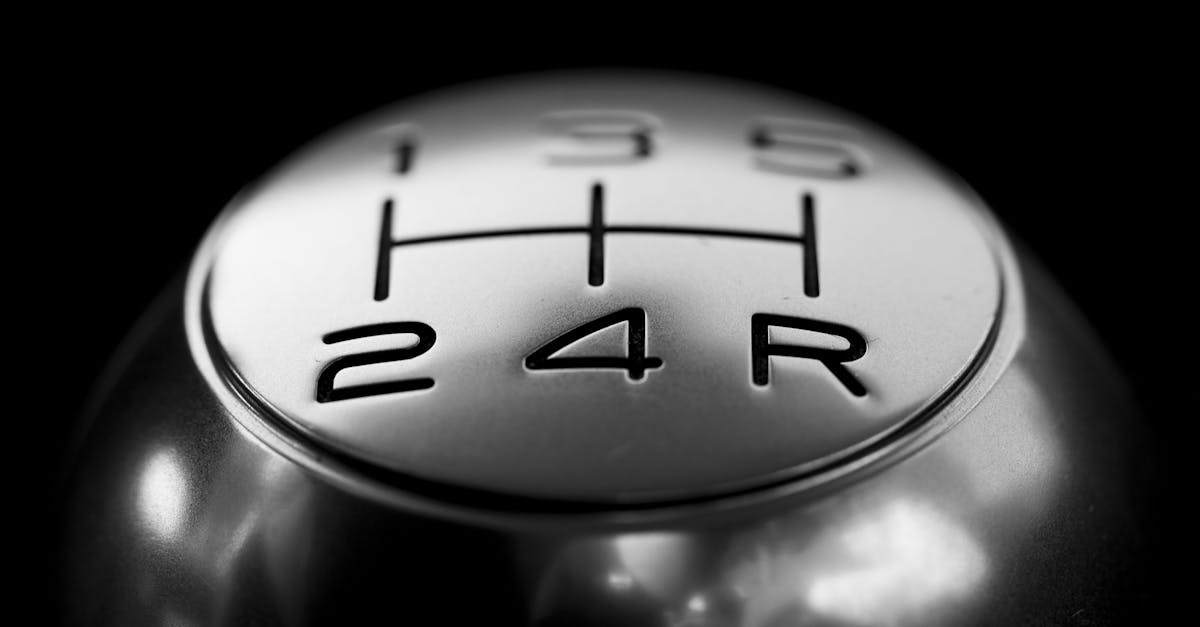 pexels-photo-248539-248539 Detailed close-up of a stainless steel gear shift knob against a black background.